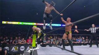 Rey Fenix uses the ropes to get some air and crush SCU