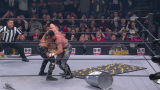 FULL GEAR: Kenny lays out a mousetrap for Moxley, but ends up getting thrown into his own torture
