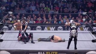 Rey Fenix is left in a puddle by Dustin Rhodes