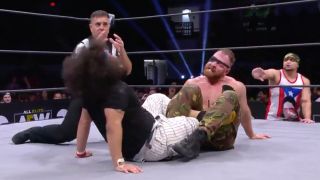 Moxley traps Ortiz in a leg sweep